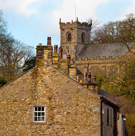 St. Leonard Church ... Downham Village Lancashire. In the foreground cottages with traditional chimney pots.