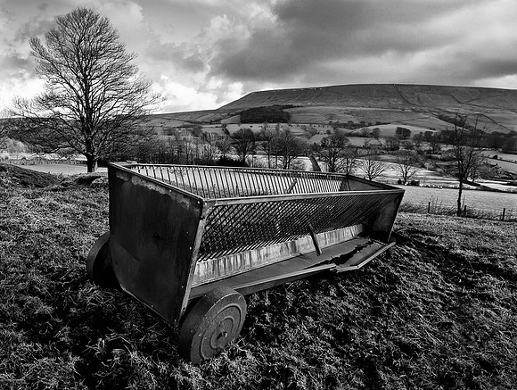 Old cattle feeder with Pendle Hill in the background.... Downham Village.