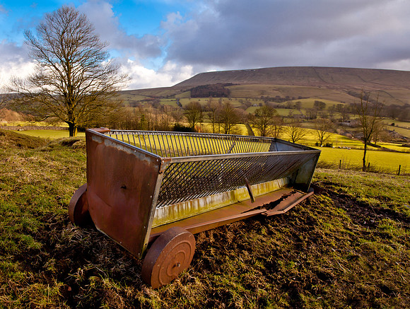 Old cattle feeder with Pendle Hill in the background.... Downham Village.